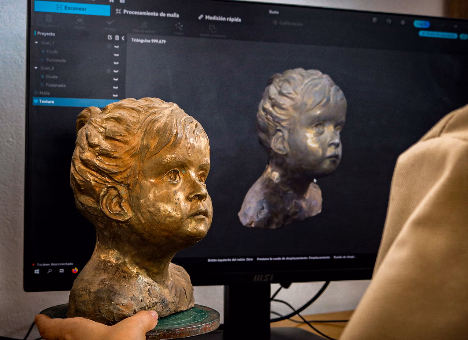 Physical sculpture beside its digital model on a screen